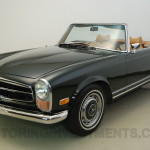 Image of dark olive Mercedes 280SL from the angle of the left front perspective